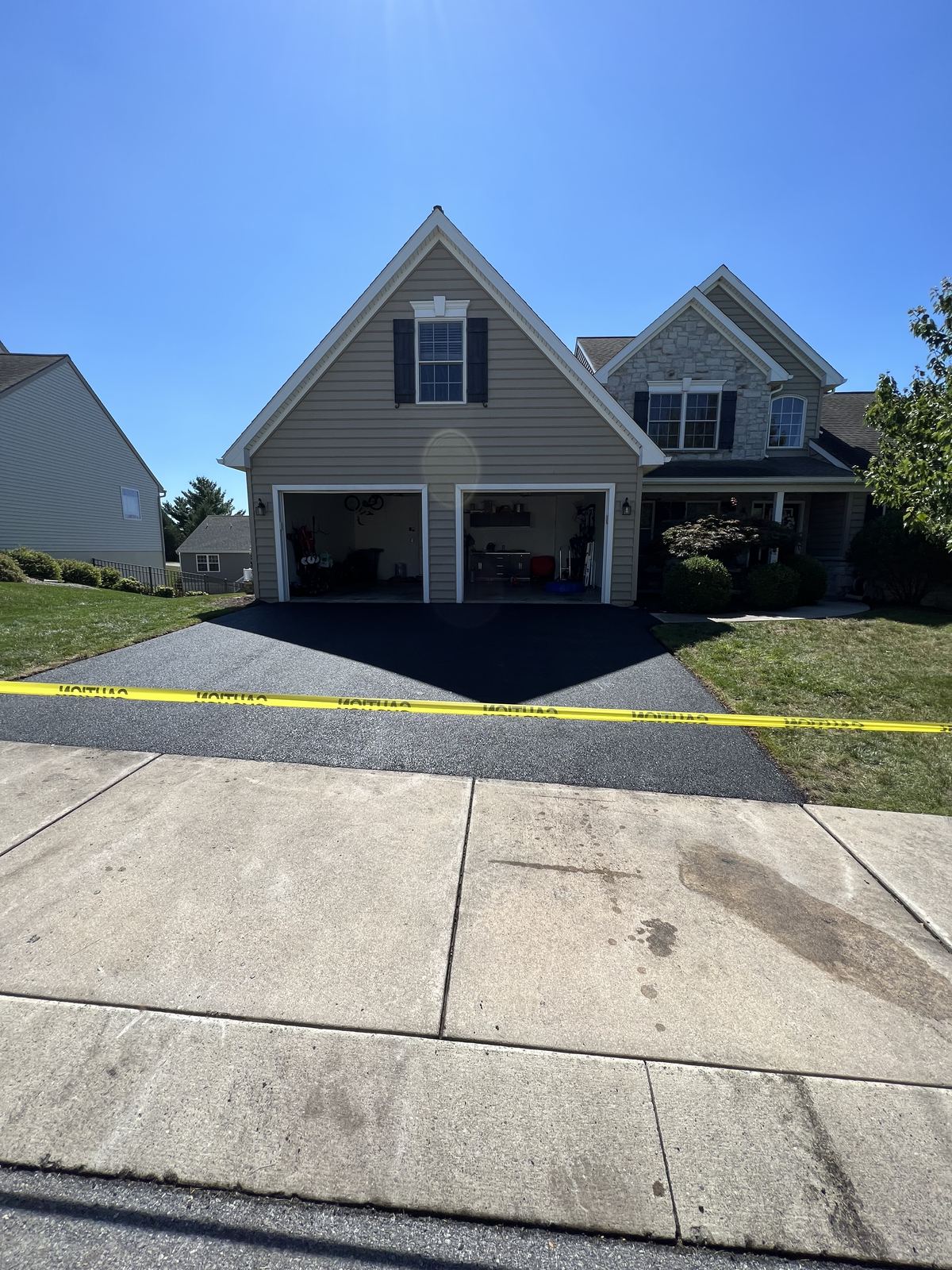 New asphalt driveway paving at two-car garage home in Lancaster PA