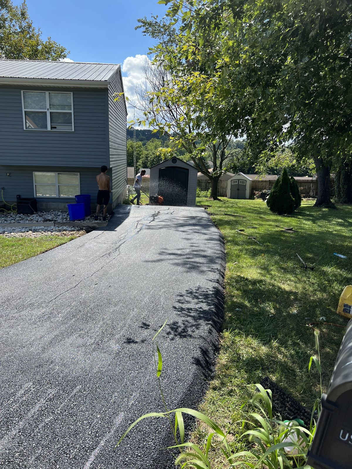 Newly repaved asphalt driveway with clean edges