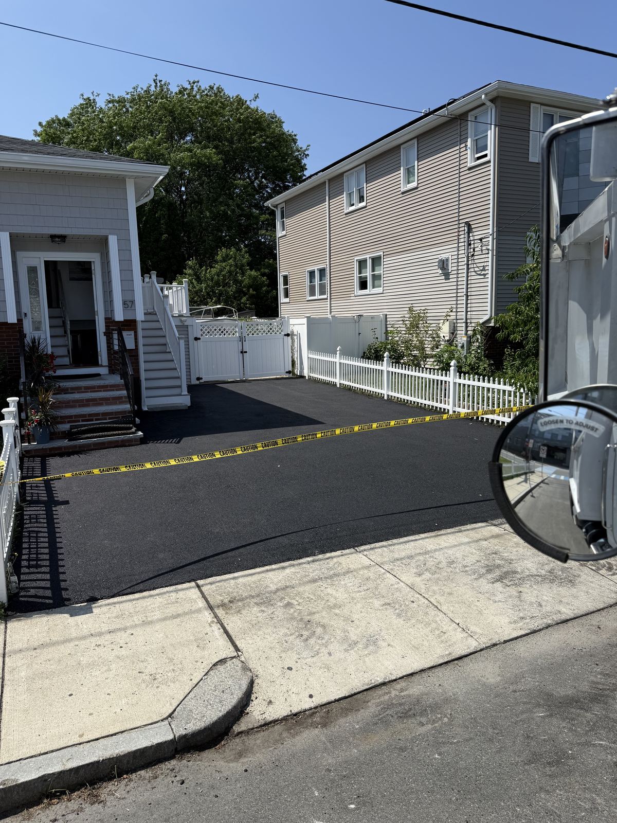Fresh asphalt residential driveway paving with clean finish
