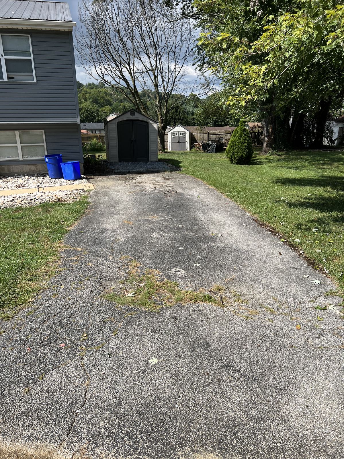 Worn cracked asphalt driveway before repaving